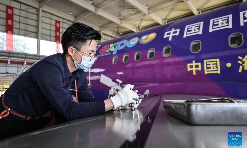 A staff member checks a themed plane to prepare for the China International Consumer Products Expo at Meilan International Airport in Haikou, south China's Hainan Province, March 7, 2023. The third China International Consumer Products Expo (CICPE) is scheduled to kick off in mid-April in south China's Hainan Province. An opening ceremony for the expo, to be held in the city of Haikou, will be held on April 10. The expo will last through April 15.(Photo: Xinhua)