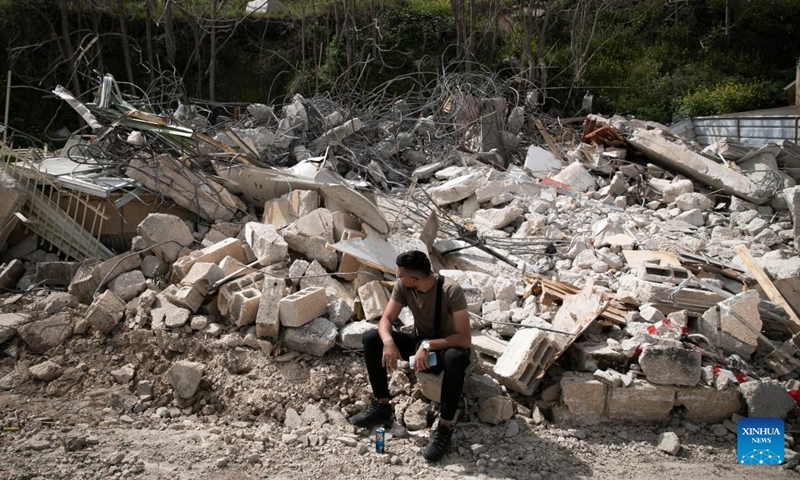 The resident of a demolished house sits beside the ruins, Wadi al-Joz neighborhood, East Jerusalem, March 6, 2023.(Photo: Xinhua)