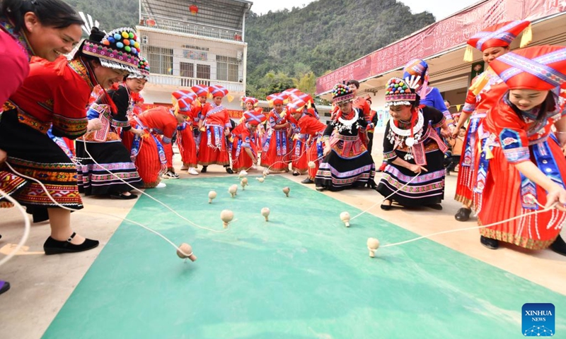 Women take part in a spinning top competition to celebrate the upcoming International Women's Day in Renliang Village of Dahua Yao Autonomous County, south China's Guangxi Zhuang Autonomous Region, March 5, 2023.(Photo: Xinhua)