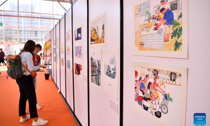 People view artworks at the Children's Book Fair in Bologna, Italy, on March 7, 2023. The 60th Bologna Children's Book Fair is held here from March 6 to March 9.(Photo: Xinhua)