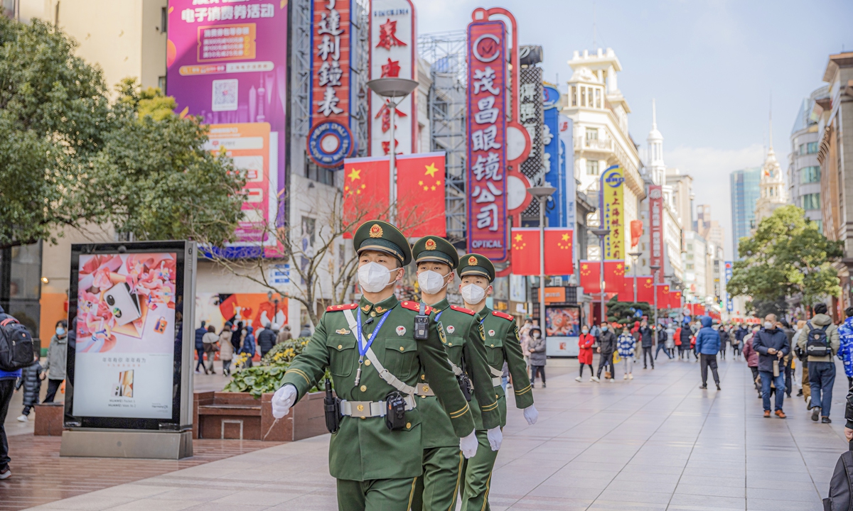Soldiers from a People's Armed Police Force unit patrol the Nanjing Road in Shanghai. Photo: Lin Jianjie
