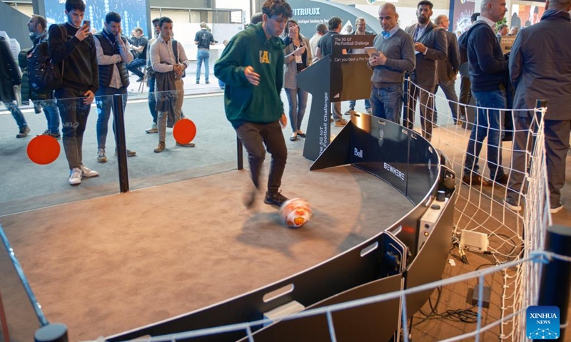 A man tries out a smart football-testing device on display at the 2023 Mobile World Congress (MWC) in Bacelona, Spain, Feb. 28, 2023. From foldable phones to rollable screens, the latest technological innovations in the mobile communication industry are on display at the 2023 Mobile World Congress (MWC), which runs here from Feb. 27 to March 2.(Photo: Xinhua)