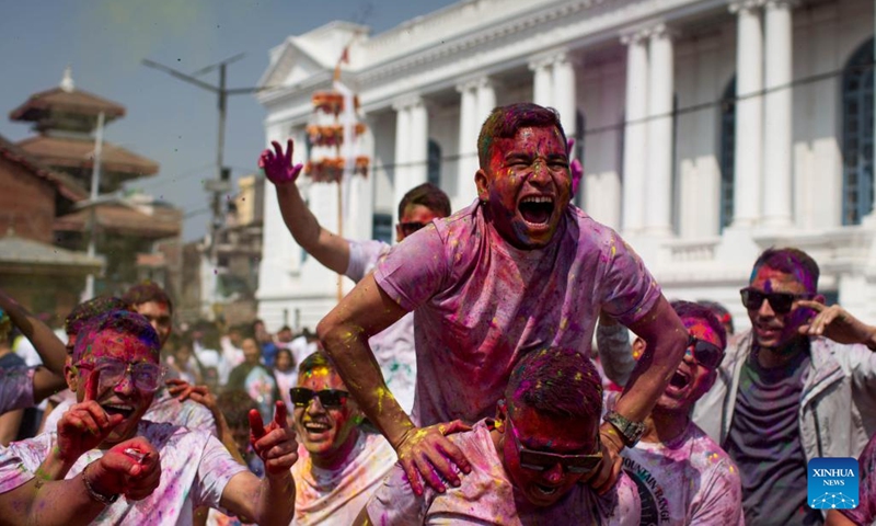 People are smeared with colored powder during the celebration of Holi Festival on the Basantapur Durbar Square in Kathmandu, Nepal, March 6, 2023.(Photo: Xinhua)