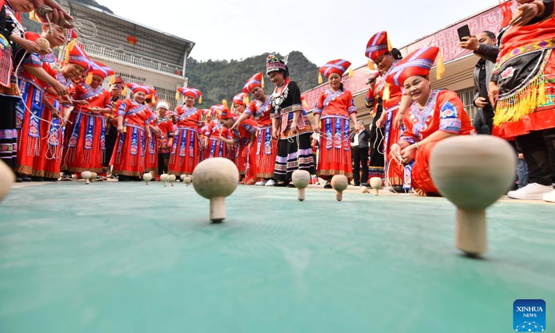 Women take part in a spinning top competition to celebrate the upcoming International Women's Day in Renliang Village of Dahua Yao Autonomous County, south China's Guangxi Zhuang Autonomous Region, March 5, 2023.(Photo: Xinhua)