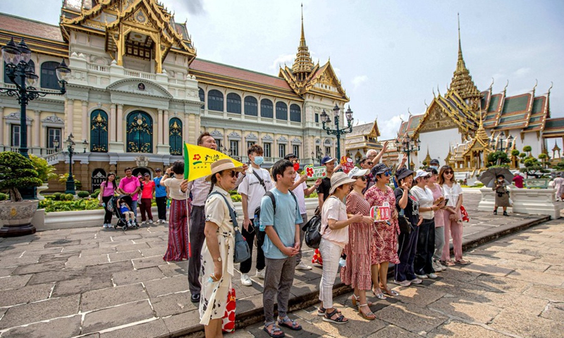 Chinese tourists pose for photos at the Grand Palace in Bangkok, Thailand on Feb. 7, 2022.(Photo: Xinhua)