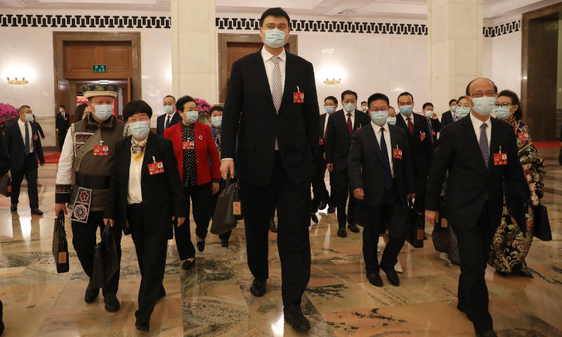 Yao Ming, president of the Chinese Basketball Association, who is also a deputy to the 14th National People’s Congress (NPC), walks out of the Great Hall of the People with other deputies after the second plenary meeting of the first session of the 14th NPC in Beijing on March 7, 2023. Photo: VCG