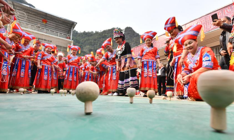 Women take part in a spinning top competition to celebrate the upcoming International Women's Day in Renliang Village of Dahua Yao Autonomous County, south China's Guangxi Zhuang Autonomous Region, March 5, 2023. (Xinhua/Huang Xiaobang)