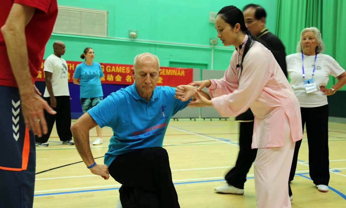 Lai Jianhui (right), associate professor in traditional health sports at Shanghai University of Sport, teaches a class. Photo:Courtesy of Lai Jianhui