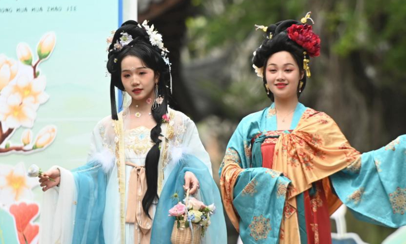 Performers display festival attire to celebrate Hua Zhao Jie, meaning Flower Festival, at a park in Fuzhou, southeast China's Fujian Province, March 11, 2023. (Xinhua/Lin Shanchuan)