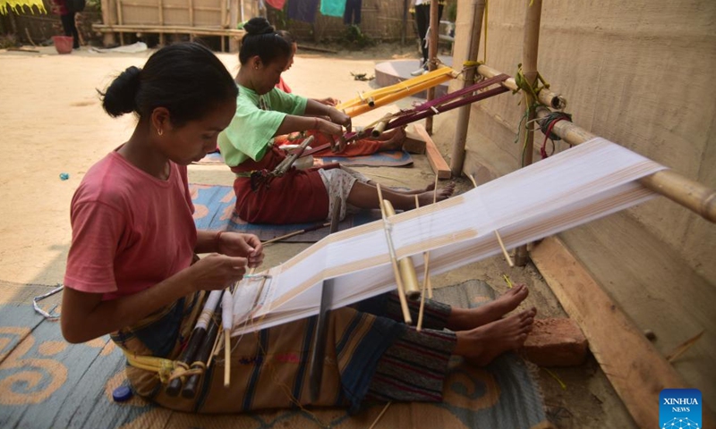 Women weave Jamborong (traditional bag) in Karbi Anglong district of India's northeastern state of Assam, March 12, 2023. (Str/Xinhua)