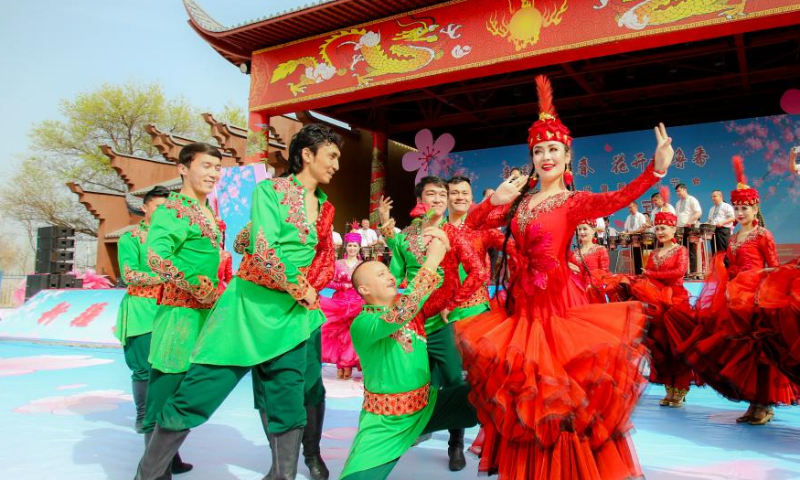 Dancers perform at the opening ceremony of an apricot blossom festival in Toksun County of Turpan, northwest China's Xinjiang Uygur Autonomous Region, March 18, 2023. The Turpan apricot blossom festival kicked off here Saturday. (Xinhua/Hao Zhao)