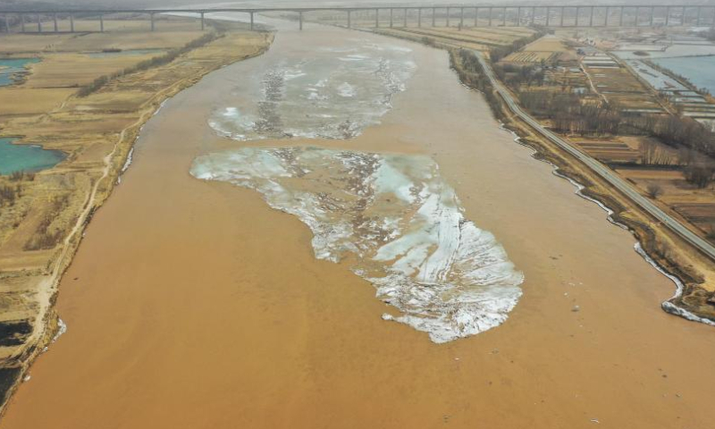 This aerial photo taken on March 11, 2023 shows the scenery along a section of the Yellow River in Togtoh County of Hohhot, north China's Inner Mongolia Autonomous Region. (Xinhua/Wang Kaiyan)