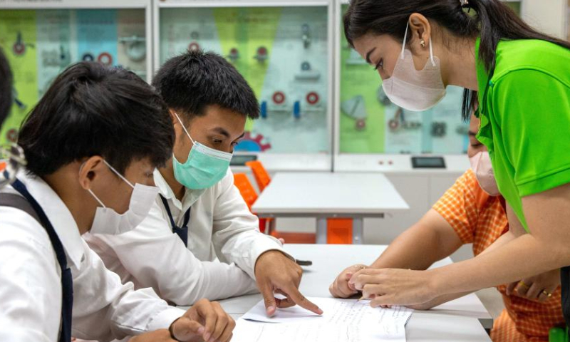 A teacher (1st R) instructs students at the Luban Workshop of Ayutthaya Technical College in Ayutthaya, Thailand, March 14, 2023. The Luban Workshop, a Chinese vocational workshop program training talents overseas, was first inaugurated in Ayutthaya Technical College in March 2016. The workshop is named after Lu Ban, an ancient Chinese craftsman that represents the Chinese tradition of craftsmanship spirit. This workshop and its training center for railway talents have trained many students for Thailand in the past seven years. (Xinhua/Wang Teng)