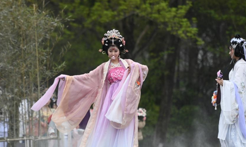 Women in olden costumes perform for visitors at Xixi National Wetland Park in Hangzhou, east China's Zhejiang Province, March 18, 2023. A series of activities was held here Saturday to celebrate a traditional flower festival or Hua Zhao Jie in Chinese. (Xinhua/Huang Zongzhi)