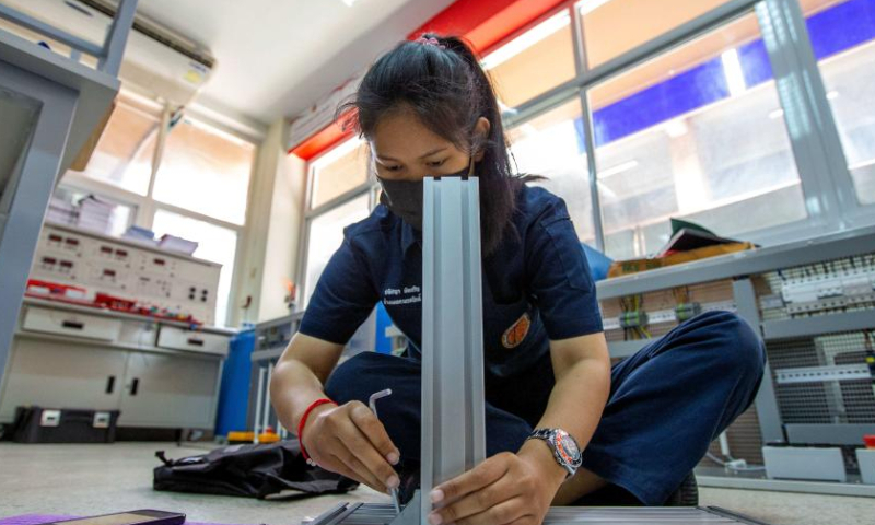A student builds an installation system of automation production line at the Luban Workshop of Ayutthaya Technical College in Ayutthaya, Thailand, March 14, 2023. The Luban Workshop, a Chinese vocational workshop program training talents overseas, was first inaugurated in Ayutthaya Technical College in March 2016. The workshop is named after Lu Ban, an ancient Chinese craftsman that represents the Chinese tradition of craftsmanship spirit. This workshop and its training center for railway talents have trained many students for Thailand in the past seven years. (Xinhua/Wang Teng)