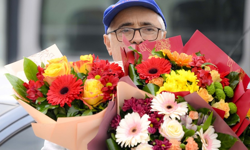 A man carries flowers on International Women's Day in the city center of Skopje, North Macedonia, March 8, 2023.(Photo: Xinhua)