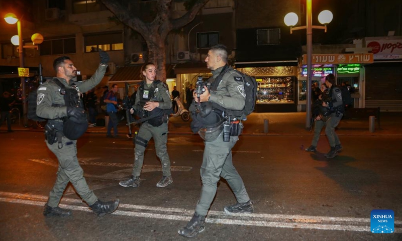 Police stand guard at the scene of a shooting attack on Dizengoff street in Tel Aviv, Israel, on March 9, 2023. A gun-wielding Palestinian man opened fire on a busy street in the Israeli city of Tel Aviv on Thursday night, injuring three individuals in what was described by Israeli officials as a terror attack. (Photo: Xinhua)