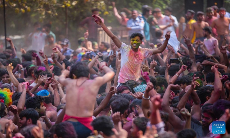 Revellers play with colored powder during a celebration of the Holi festival in New Delhi, India, March 8, 2023. (Xinhua/Javed Dar)