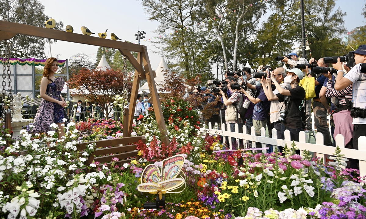 Visitors take photos of a model at the Hong Kong Flower Show at Victoria Park, Hong Kong on March 9, 2023. The show, which aims to promote horticulture and green awareness among the public, will be held until March 19, 2023 after a three-year hiatus. Photo: VCG