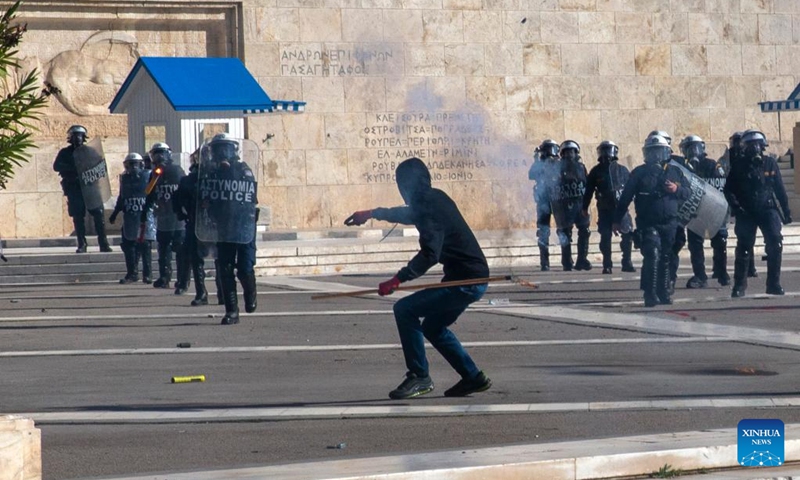 A protester clashes with riot police during a demonstration in front of the Greek Parliament in Athens, Greece, on March 8, 2023. Greek government announced a set of measures aimed to improve the safety of railway system on Wednesday, in the wake of the train collision last week in central Greece that resulted in 57 deaths. (Photo: Xinhua)