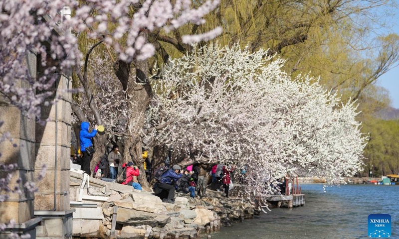 Tourists take photos in the Summer Palace in Beijing, capital of China, on March 15, 2023.(Photo: Xinhua)
