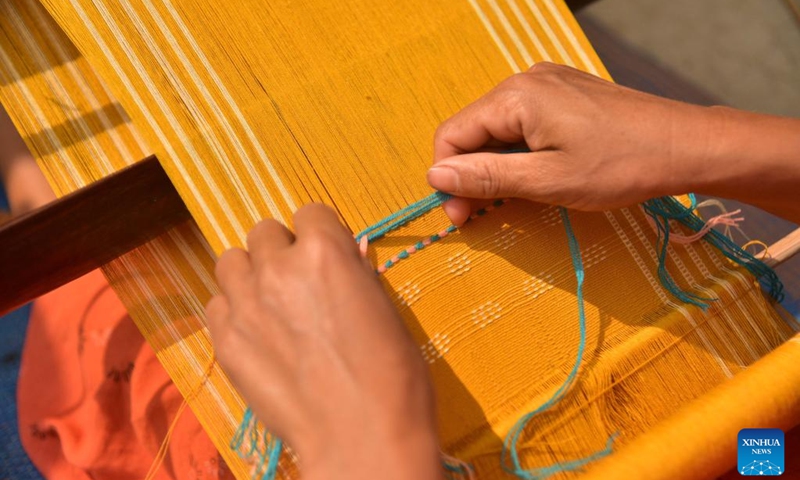A woman weaves a Jamborong (traditional bag) in Karbi Anglong district of India's northeastern state of Assam, March 12, 2023.(Photo: Xinhua)