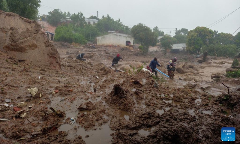 People walk in the mud in Chilobwe, Blantyre, Malawi, on March 13, 2023. The death toll from Tropical Cyclone Freddy in Malawi reached 99 Monday evening with 85 deaths recorded in the commercial city of Blantyre alone, authorities have confirmed.(Photo: Xinhua)