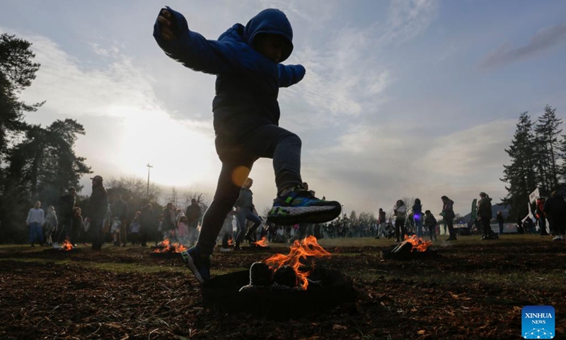 A child leaps over a bonfire during the fire festival in celebration of Nowruz at Ambleside Park in West Vancouver, British Columbia, Canada, on March 14, 2023. The Persian New Year, or Nowruz, is celebrated by Canada's Iranian community with a concert, fires, and festivities in mid-March each year.(Photo: Xinhua)