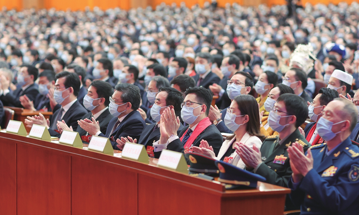 Deputies to the 14th National People's Congress (NPC) applaud during the fifth plenary meeting of the first 
session of the 14th NPC at the Great Hall of the People in Beijing on March 12, 2023. Photo: cnsphoto
