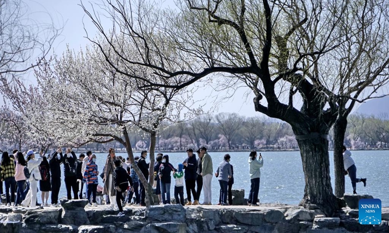 Tourists view blooming flowers at the Summer Palace in Beijing, capital of China, March 12, 2023. (Xinhua/Li Xin)