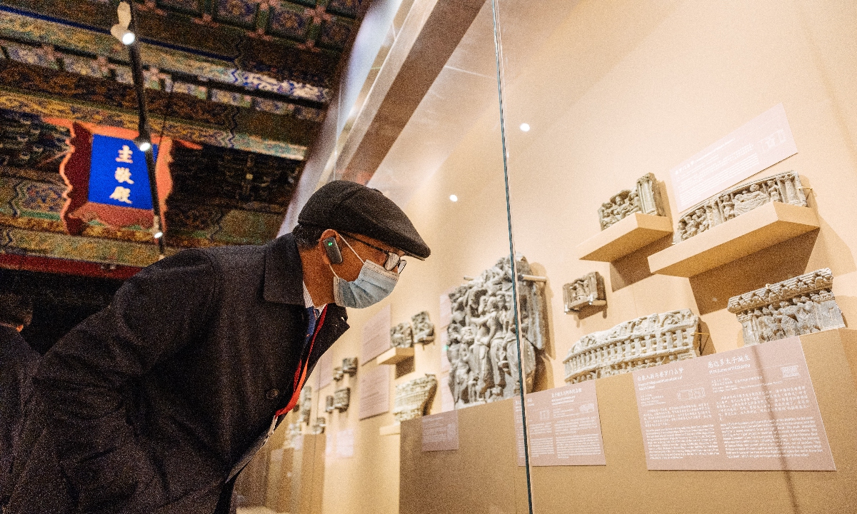 A spectator examines exhibits at the <em>Gandhara Heritage along the Silk Road: A Pakistan-China Joint Exhibition</em> at the Palace Museum in Beijing, on March 15, 2023. Photo: Li Hao/Global Times