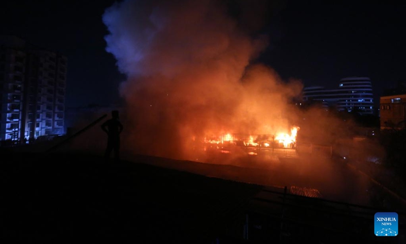 This photo shows a fire ripping through houses at a slum in Dhaka, Bangladesh on March 13, 2023. A massive fire tore through one of the largest slums in the Bangladeshi capital Dhaka, destroying at least 100 shanties. (Photo:Xinhua)