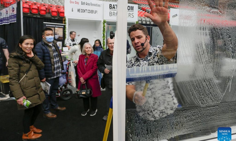 People watch a window cleaning demonstration at the BC Home and Garden Show in Vancouver, British Columbia, Canada, on March 16, 2023. The annual event featured over 300 exhibitors and expert presentations and will run from March 16 to March 19 at the BC Place stadium.(Photo: Xinhua)