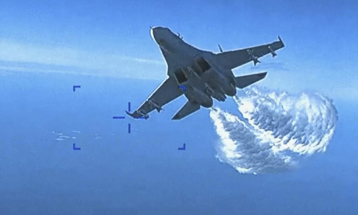 A Russian Su-27 approaches the back of the MQ-9 drone over the Black Sea. The Pentagon has released footage of what it says is a Russian aircraft conducting an intercept of a US Air Force surveillance drone in international airspace over the Black Sea.