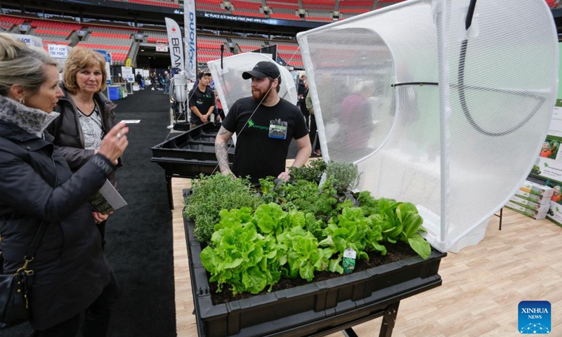 People look at a mobile planting pot at the BC Home and Garden Show in Vancouver, British Columbia, Canada, on March 16, 2023. The annual event featured over 300 exhibitors and expert presentations and will run from March 16 to March 19 at the BC Place stadium.(Photo: Xinhua)