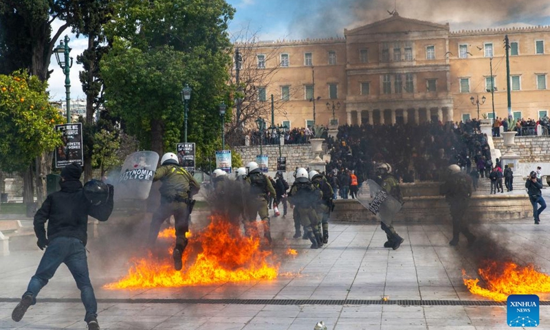 People clash with riot police during a demonstration in Athens, Greece, on March 16, 2023. Greece's public services, including transport, were paralyzed on Thursday by a 24-hour nationwide general strike called by labor unions over the deadly train accident last month.(Photo: Xinhua)