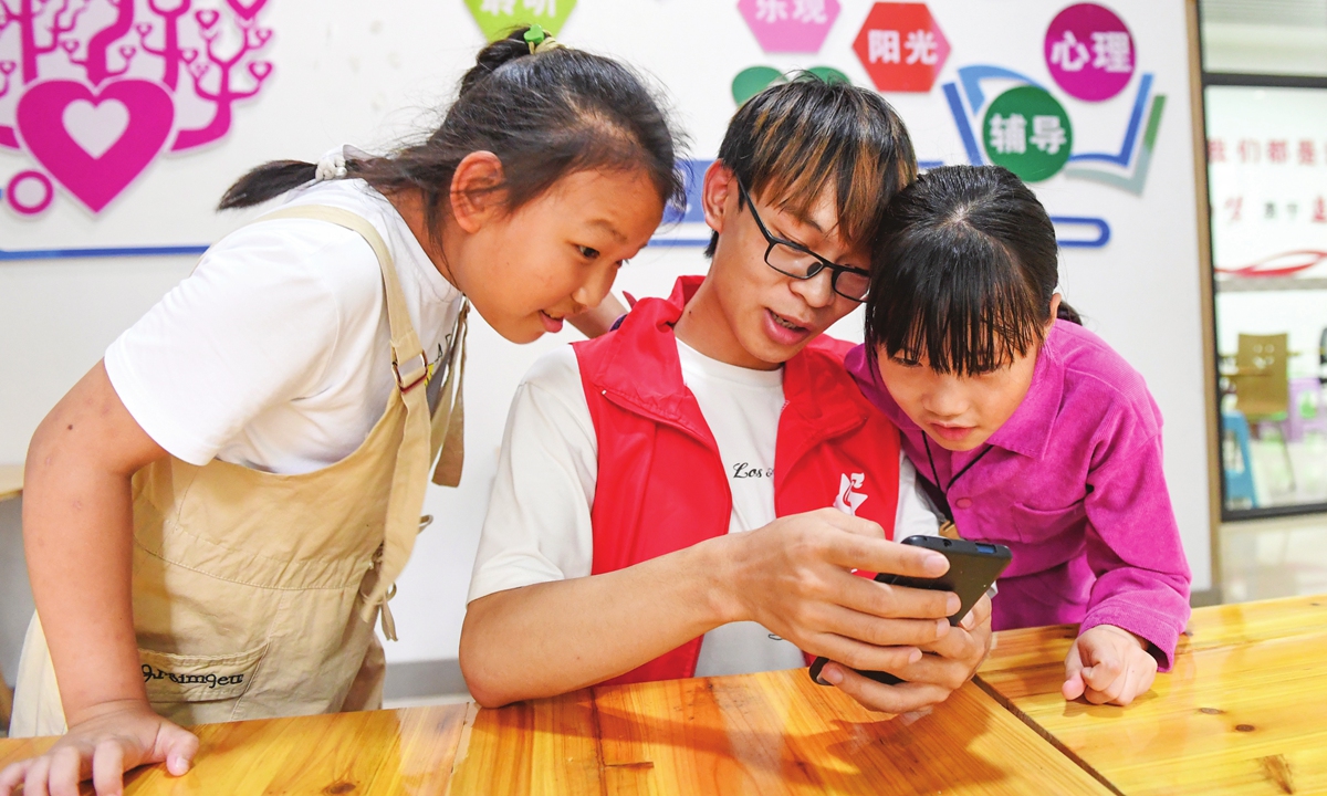 College student volunteers give lessons to children in Huairen, Southwest China's Guizhou Province on July 21, 2021. Photo: VCG 