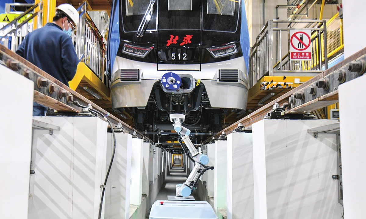 A robot checks a subway train in Beijing on March 17, 2023. As China pursues high-quality development, the global manufacturing powerhouse expects to cultivate an upgraded manufacturing sector equipped with advanced technologies to boost productivity and drive economic growth. Photo: VCG