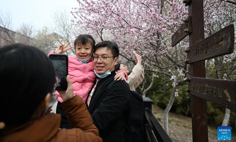 Tourists take photos on the peach blossom embankment along the Grand Canal in Hongqiao district, north China's Tianjin, on March 19, 2023. As the weather gets warmer, the peach blossoms here are in full bloom and have attracted many tourists. (Xinhua/Zhao Zishuo)
