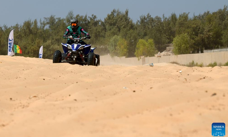 A racer competes during a beach motocross race near Lake Retba in Senegal on March 19, 2023. (Xinhua/Han Xu)
