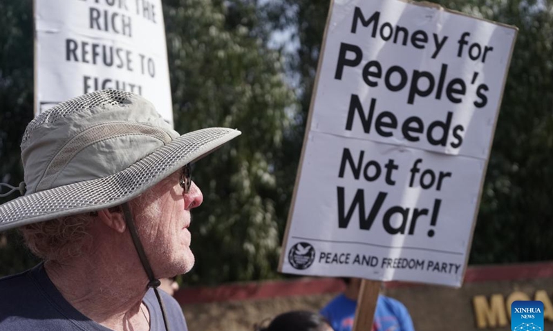 A protester is seen in front of Marine Corps Air Station Miramar, 25 kilometers north of downtown San Diego, California, the United States, March 18, 2023. Anti-war organizations held rallies in Los Angeles and San Diego on Saturday in the run-up to the 20th anniversary of the U.S. invasion of Iraq, which started on March 20, 2003. (Photo by Zeng Hui/Xinhua)