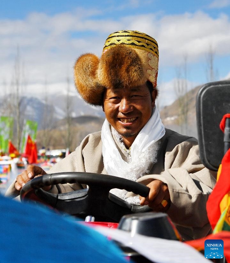 A local farmer dressed up in traditional Tibetan costume pilots an agricultural machine at a spring plowing ceremony held in Changga Village, Linzhou County of southwest China's Tibet Autonomous Region, March 16, 2023. (Photo:Xinhua)