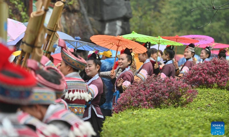 People of Miao ethnic group welcome tourists from Zhanjiang City of south China's Guangdong Province at a scenic spot in Rongshui Miao Autonomous County, south China's Guangxi Zhuang Autonomous Region, on March 19, 2023. More than 600 tourists from Zhanjiang took a special tourist train to Rongshui Miao Autonomous County to experience the charm of ethnic culture. (Xinhua/Huang Xiaobang)