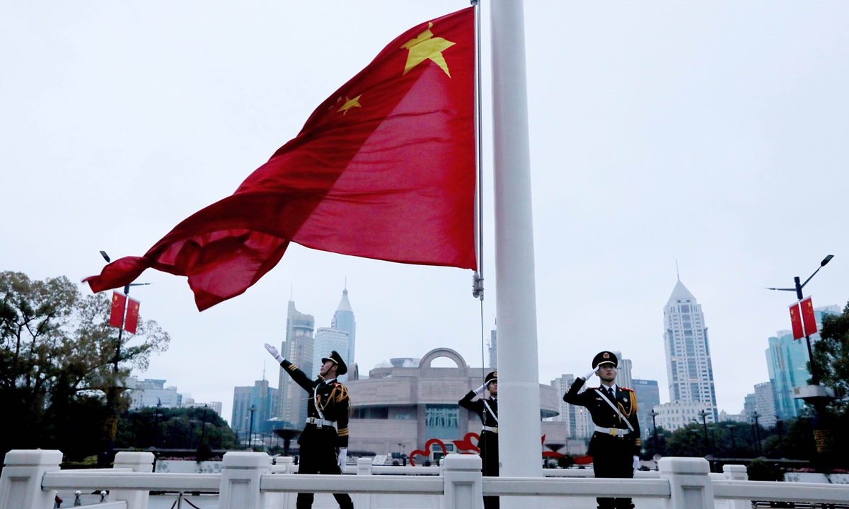 Soldiers from the People's Armed Police Force unit raise the Chinese national flag at People's Square in Shanghai on February 24, 2023. Photo: Chen Xia/GT