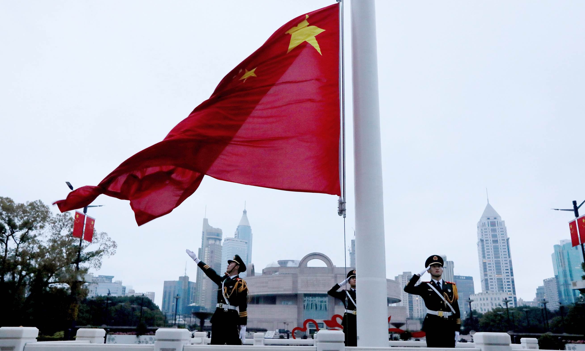 Soldiers from the People's Armed Police Force unit raise the Chinese national flag at People's Square in Shanghai on February 24, 2023. Photo: Chen Xia/GT