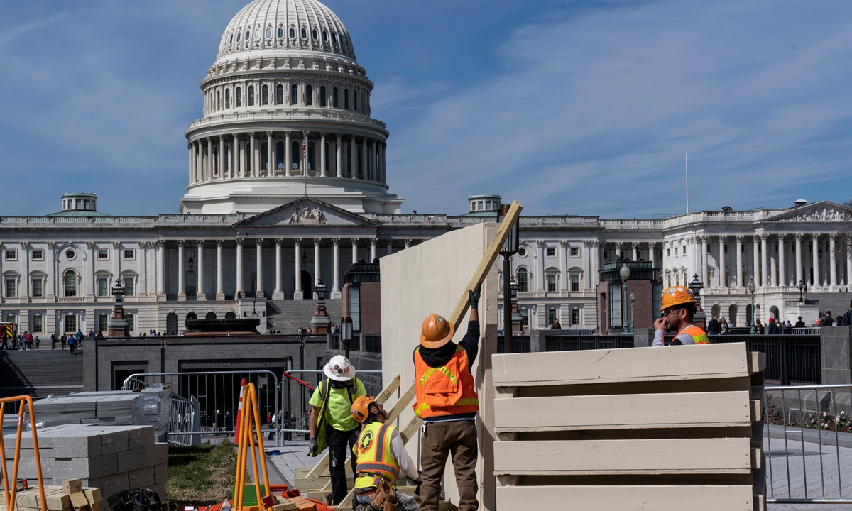 Workers erect panels on the East side of the Capitol in Washington, DC on March 21, 2023 in case of unrest from supporters of former US president Donald Trump. New York prosecutors are reportedly set to charge Trump over alleged hush money paid to a porn star. Photo: VCG