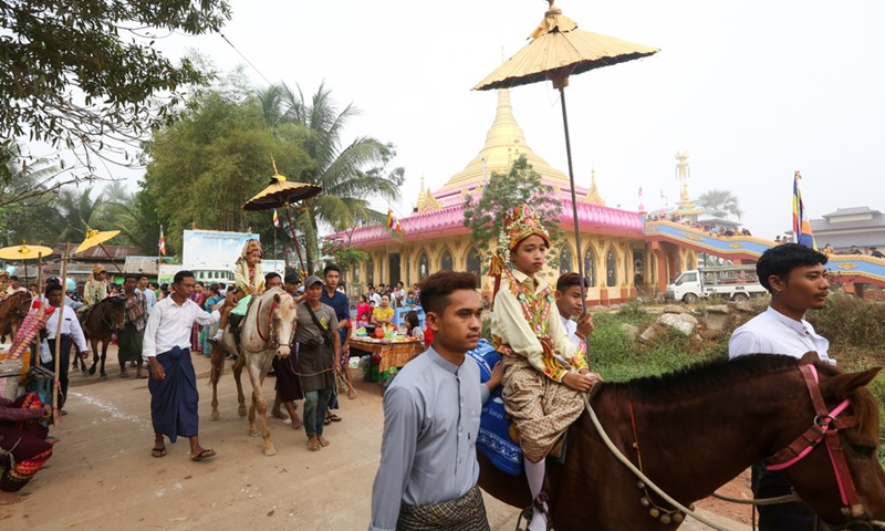 Boys in traditional attire ride horses during the Shinbyu novitiation ceremony in Dala township of Yangon, Myanmar, on March 19, 2023.(Photo: Xinhua)