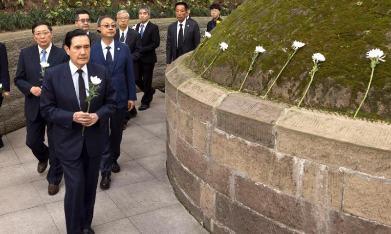 Ma Ying-jeou, former chairman of the Chinese Kuomintang (KMT) party, presents a flower to the tomb of General Zhang Zizhong, a senior officer killed during the Chinese People's War of Resistance Against Japanese Aggression, while visiting a cemetery dedicated to the general, in southwest China's Chongqing Municipality, April 4, 2023. (Xinhua)