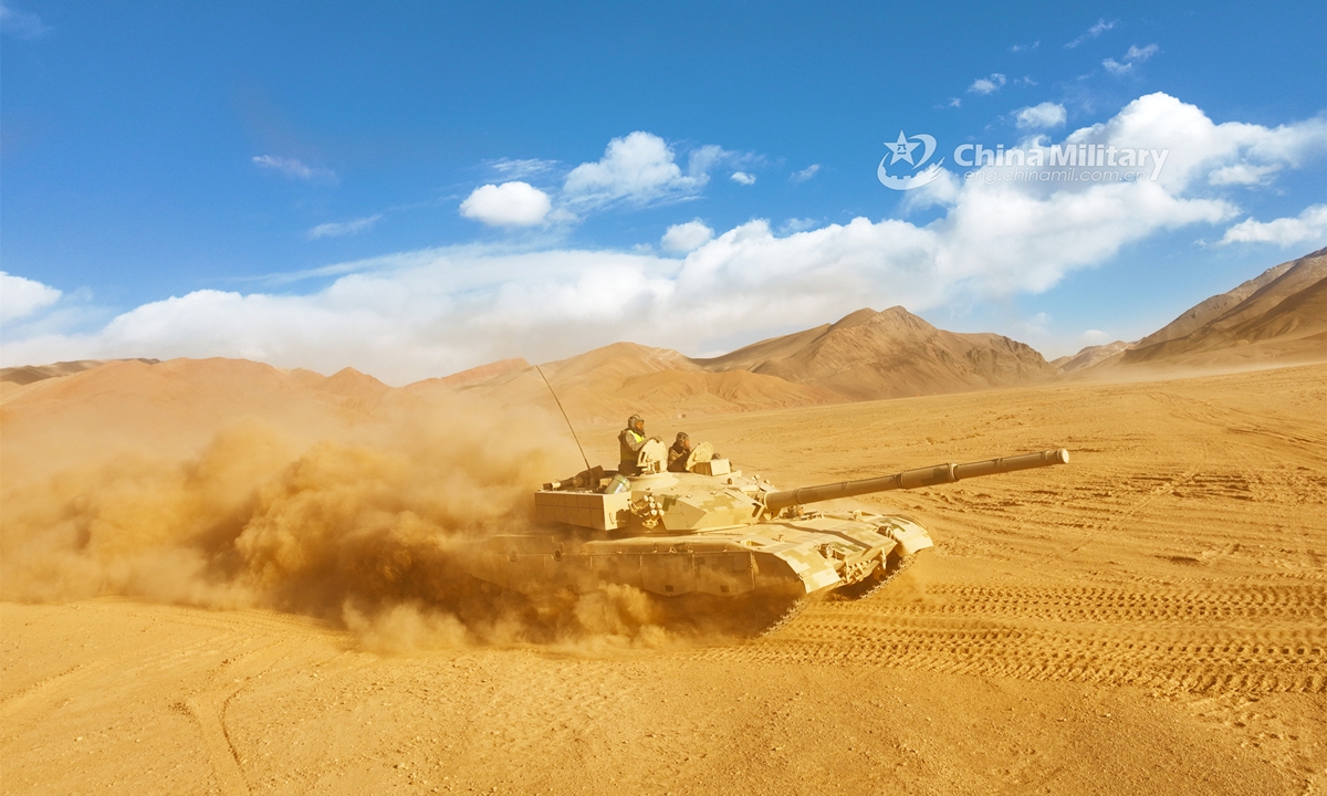 A main battle tank attached to a tank element under the PLA 77th Group Army rumbles through a mound of dust en route to a designated field during a field training exercise in northwest China’s Gobi desert in mid March, 2023. (eng.chinamil.com.cn/Photo by Xue Zongyan and Liu Shanlin)
