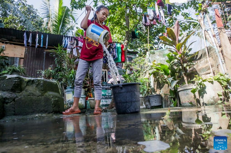 A resident fetches water from a well at a residential area on the occasion of World Water Day in Quezon City, the Philippines, March 22, 2023. (Xinhua/Rouelle Umali)